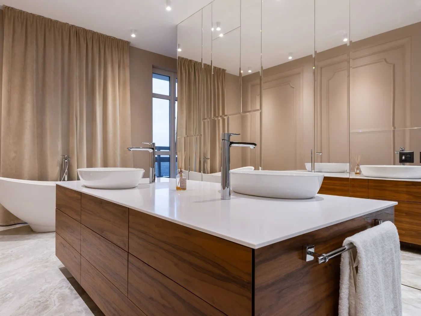 Finished bathroom remodel in the Longview Heights area of ZIP 98632 — double vessel sinks on a walnut vanity with a freestanding tub beyond